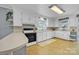 Bright kitchen featuring white cabinetry, neutral countertops and updated appliances at 1770 Nc 90 W Hwy, Taylorsville, NC 28681