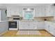 Well-lit kitchen featuring crisp white cabinets, modern appliances, and a bright window at 1770 Nc 90 W Hwy, Taylorsville, NC 28681