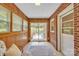Bright sun room boasting wood paneling, brick accents, and sliding doors to a charming outdoor deck at 1770 Nc 90 W Hwy, Taylorsville, NC 28681