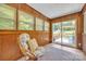 Bright sun room boasting wood paneling, brick accents, and sliding doors to a charming outdoor deck at 1770 Nc 90 W Hwy, Taylorsville, NC 28681