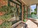 Charming front porch with double doors, potted plants, and a porch swing at 18419 Dembridge Dr, Davidson, NC 28036