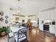 Spacious kitchen featuring white cabinetry, hardwood floors, and an island at 18419 Dembridge Dr, Davidson, NC 28036