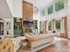 Bright living room with stone fireplace, built-in shelves, hardwood floors and large windows at 18419 Dembridge Dr, Davidson, NC 28036