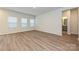 Bright living room with three large windows and hardwood floors at 1983 Paddlewheel Dr, Stanley, NC 28164
