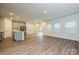 Open concept living space with hardwood floors and stainless appliances at 1983 Paddlewheel Dr, Stanley, NC 28164