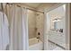 This bathroom has a shower and tub combo, neutral tile, and opens to a vanity area with lots of storage at 2004 Garden View Ln, Weddington, NC 28104