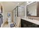 Modern bathroom features a glass shower, granite countertop, and dark wood vanity for a luxurious feel at 2004 Garden View Ln, Weddington, NC 28104