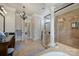 Well-lit bathroom with walk-in shower, soaking tub, dual vanities, and stylish fixtures at 2004 Garden View Ln, Weddington, NC 28104