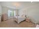 Charming bedroom with a four-poster bed, soft lighting, and ample natural light at 2004 Garden View Ln, Weddington, NC 28104