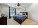 Cozy bedroom with a dark wood bed frame, shuttered windows, and an elegant ceiling fan at 2004 Garden View Ln, Weddington, NC 28104