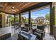 Inviting covered patio with outdoor seating, a fire pit, and a view of the sparkling pool at 2004 Garden View Ln, Weddington, NC 28104