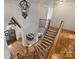 Grand foyer with curved staircase, hardwood floors, and elegant chandelier lighting at 2004 Garden View Ln, Weddington, NC 28104