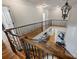 Elegant foyer with wood floors, an iron railing, and a view of the living room at 2004 Garden View Ln, Weddington, NC 28104