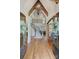 Grand foyer with soaring ceilings, wood floors, and a curved staircase creates a stunning entrance at 2004 Garden View Ln, Weddington, NC 28104