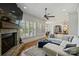 Spacious living room with a stone fireplace, comfortable seating, and large windows with shutters at 2004 Garden View Ln, Weddington, NC 28104