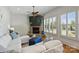 Cozy living room with stone fireplace, large windows with shutters, and comfortable white sectional at 2004 Garden View Ln, Weddington, NC 28104