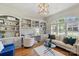 Home office with built-in shelving, hardwood floors, and a view of the landscaped exterior at 2004 Garden View Ln, Weddington, NC 28104