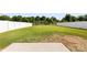 Fenced backyard showcasing a large lawn with vibrant green grass and mature trees at 2104 New Hope Branch Way, Belmont, NC 28012