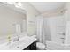 Well-lit bathroom featuring a shower-tub combo, vanity with sink, neutral walls, and decorative accents at 2104 New Hope Branch Way, Belmont, NC 28012
