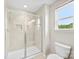 Bright bathroom featuring a tiled shower with glass door and natural light from the window at 2104 New Hope Branch Way, Belmont, NC 28012