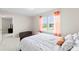 Well-lit bedroom boasting a plush bed, large window with sheer curtains, and a cozy cushioned bench at 2104 New Hope Branch Way, Belmont, NC 28012