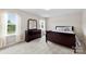 Spacious carpeted bedroom with a large window, dresser with mirror, and comfortable furnishings at 2104 New Hope Branch Way, Belmont, NC 28012