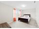 Comfortable carpeted bedroom featuring a wooden bed frame, soft lighting, and sheer curtains for ample natural light at 2104 New Hope Branch Way, Belmont, NC 28012