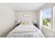 Cozy bedroom with soft lighting, comfortable bed, and view of the outdoors through a large window at 2104 New Hope Branch Way, Belmont, NC 28012