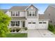 Charming two-story home featuring a welcoming front porch and a two-car garage at 2104 New Hope Branch Way, Belmont, NC 28012