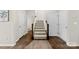 Inviting hallway with wood floors and carpeted stairs, showcasing access to multiple rooms and levels at 2104 New Hope Branch Way, Belmont, NC 28012