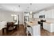 Modern eat-in kitchen featuring a center island, stainless steel appliances, and a wooden dining table at 2104 New Hope Branch Way, Belmont, NC 28012
