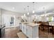 Kitchen island with granite countertops, stainless steel appliances, and hardwood floors at 2104 New Hope Branch Way, Belmont, NC 28012
