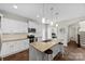 Stylish kitchen featuring a center island with seating, modern appliances, and ample counter space at 2104 New Hope Branch Way, Belmont, NC 28012