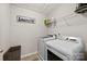 Efficient laundry room with modern washer and dryer, overhead shelving, and functional organization at 2104 New Hope Branch Way, Belmont, NC 28012