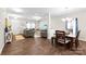 Open-concept living space with a dining area, cozy seating, and plenty of natural light at 2104 New Hope Branch Way, Belmont, NC 28012