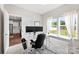 Well-lit office with white desk, dual monitors, and window view, conveniently located near the kitchen at 2104 New Hope Branch Way, Belmont, NC 28012