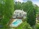 Aerial view of backyard oasis featuring a home, deck, and a pool at 21404 Blakely Shores Dr, Cornelius, NC 28031