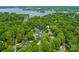 Aerial view of waterfront property with a private dock and lush trees at 21404 Blakely Shores Dr, Cornelius, NC 28031