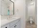 Bright bathroom featuring modern fixtures, a stylish mirror, and white cabinets for a clean, contemporary look at 21404 Blakely Shores Dr, Cornelius, NC 28031