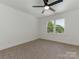 Spacious bedroom with large window, offering natural light and views of the surrounding lush greenery at 21404 Blakely Shores Dr, Cornelius, NC 28031