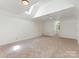 Large bonus room featuring skylights, neutral carpet, and ample natural light, creating a flexible space at 21404 Blakely Shores Dr, Cornelius, NC 28031