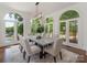 Elegant dining room with large windows, a modern chandelier, and seating for eight, perfect for entertaining at 21404 Blakely Shores Dr, Cornelius, NC 28031