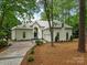 Stunning white home featuring beautiful landscaping, driveway and attached garage at 21404 Blakely Shores Dr, Cornelius, NC 28031