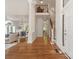 Bright foyer featuring hardwood floors, staircase, and a view into the formal living spaces at 21404 Blakely Shores Dr, Cornelius, NC 28031