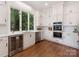 Modern kitchen with white cabinetry, stainless appliances, and a large window overlooking the yard at 21404 Blakely Shores Dr, Cornelius, NC 28031