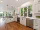Bright kitchen features white cabinets, stainless appliances and a large garden view window at 21404 Blakely Shores Dr, Cornelius, NC 28031