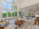 This bright living room includes large windows with views and comfortable seating at 21404 Blakely Shores Dr, Cornelius, NC 28031