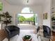 Inviting seating area with comfortable seating, bi-fold doors, deck access and views of trees at 21404 Blakely Shores Dr, Cornelius, NC 28031