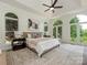 Luxurious main bedroom with arched windows, tray ceilings, and neutral decor, creating a serene retreat at 21404 Blakely Shores Dr, Cornelius, NC 28031
