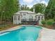 Luxury home featuring a patio, inground pool, and manicured lawn at 21404 Blakely Shores Dr, Cornelius, NC 28031